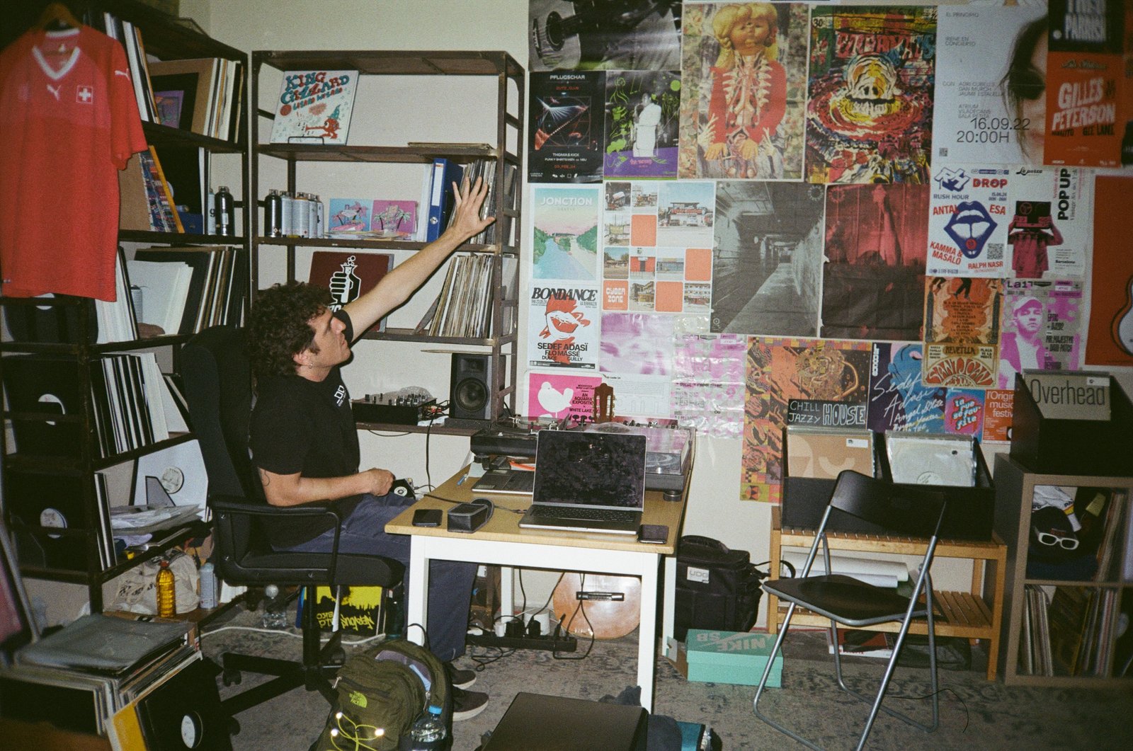 The Papa Jams studio: turntables, laptop and a wall covered in posters and records